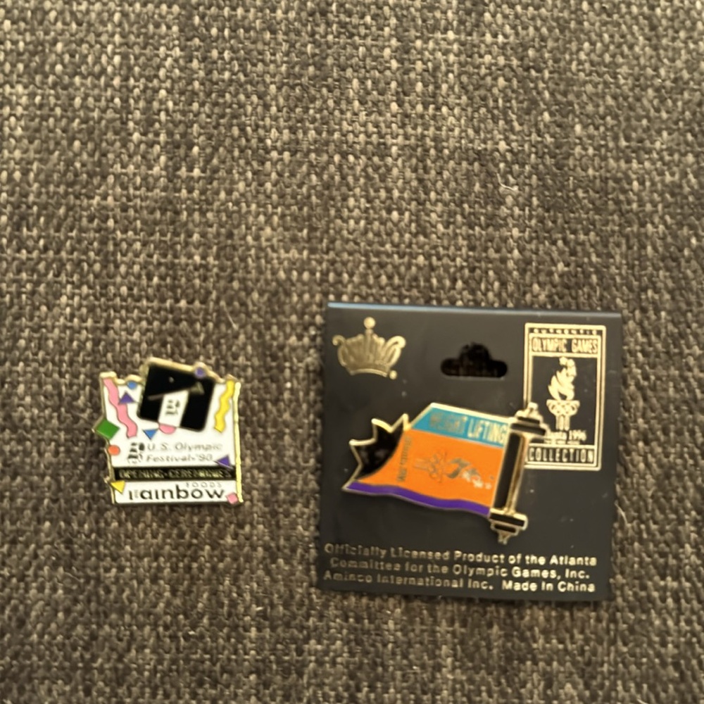 Two vintage Olympic game pins, 1990 and 1996